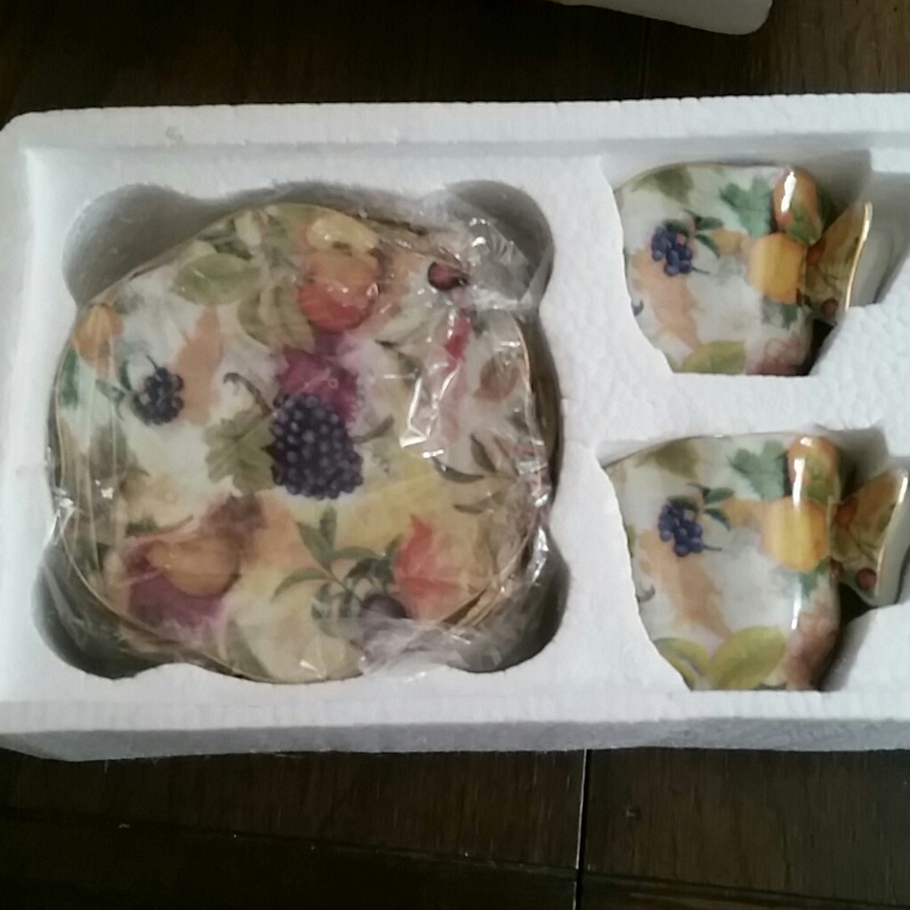 Two sets of demitasse cups and saucers
